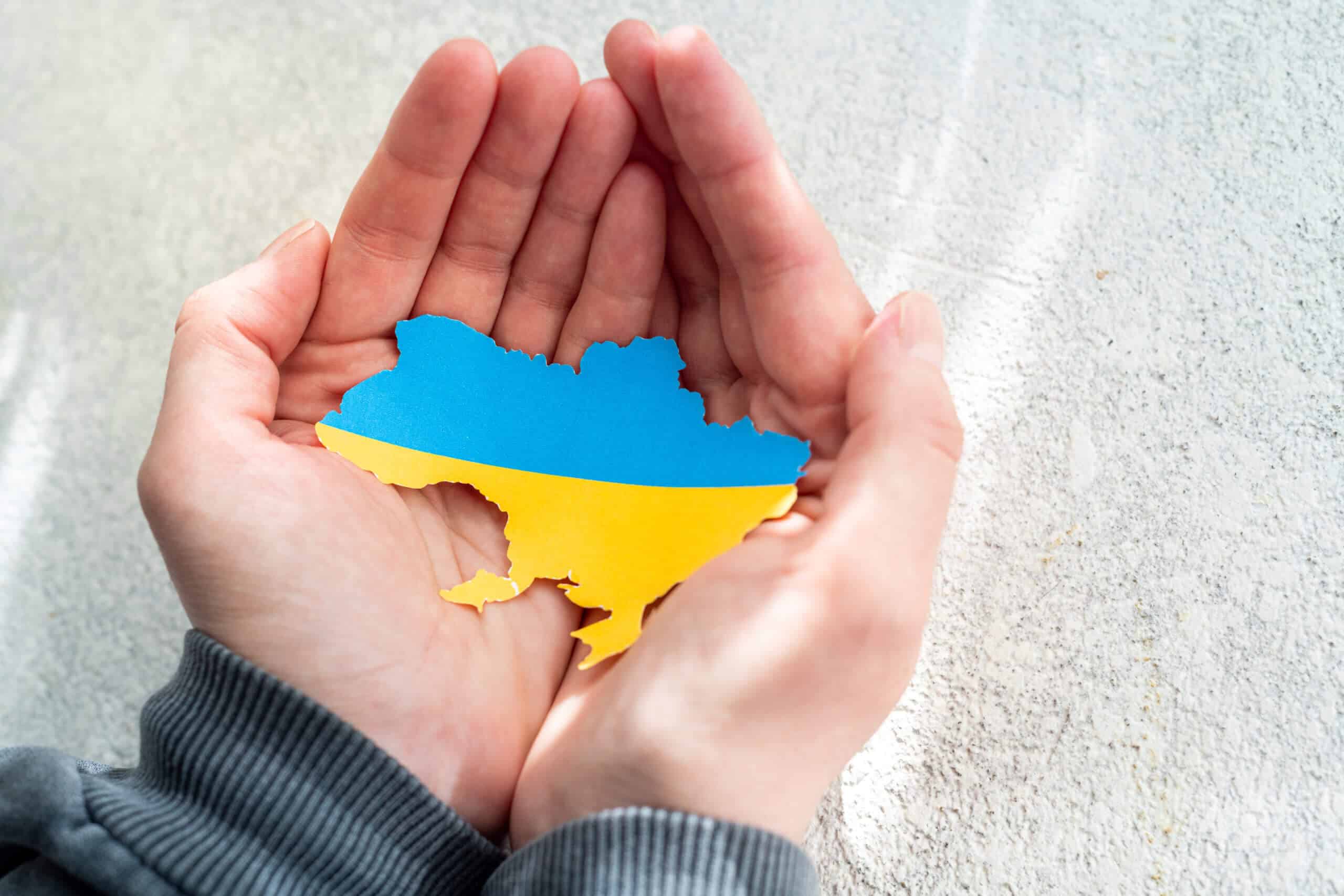 hands holding ukranian flag