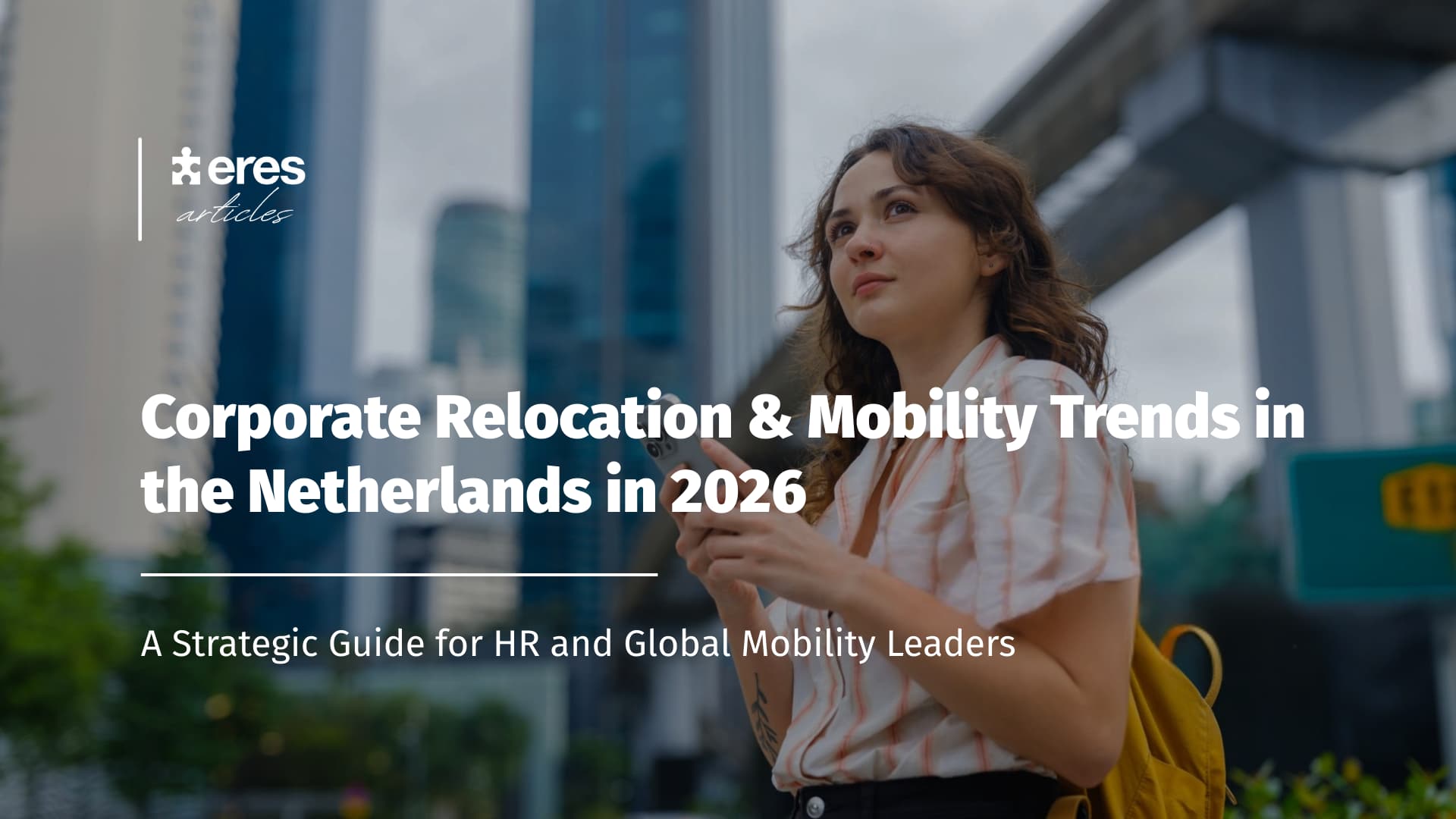 Young expat looking at her phone in the street - Global Mobility in the Netherlands